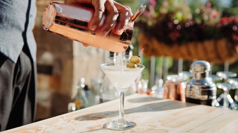 pouring martini in a glass