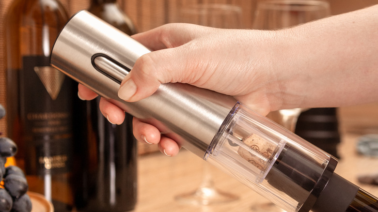Electric wine opener in use