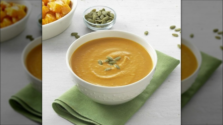 Squash soup in bowl with pumpkin seeds