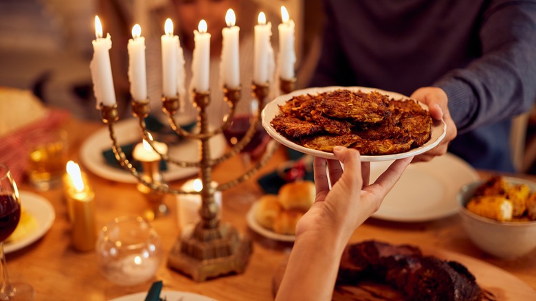 latkes on plate and menorah 