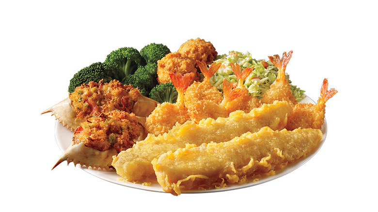 Plate with fried fish fillets, stuffed crab shells, fried shrimp, broccoli, and coleslaw