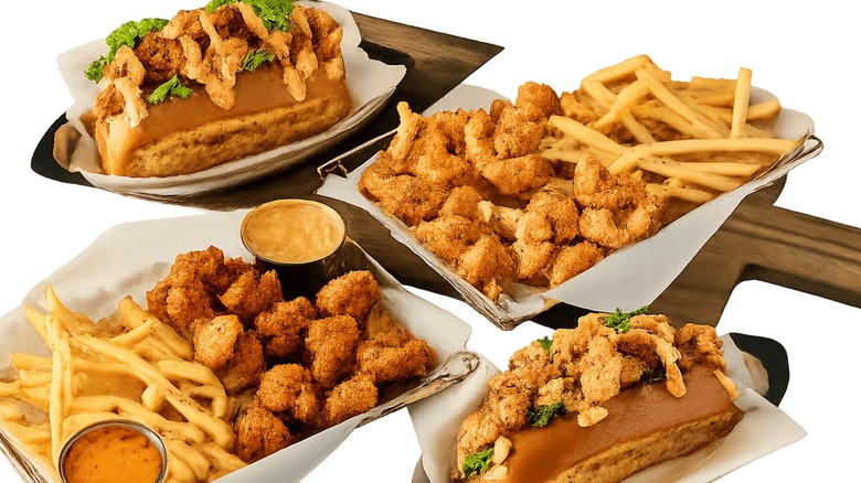 Two Smashburger fried shrimp baskets with fries and two orders of Smashburger shrimp rolls in toasted bread with drizzled sauce