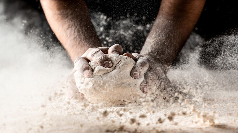 hands kneading dough