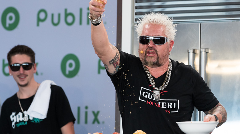 Guy Fieri sprinkles cheese