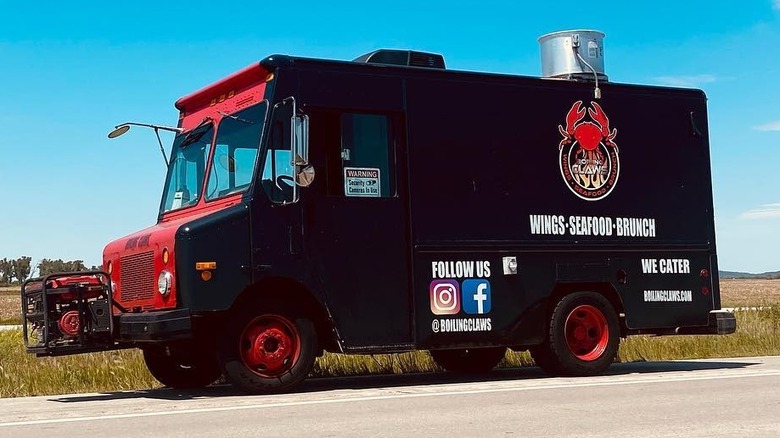 Boiling Claws food truck on the road in front of blue sky