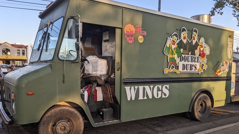 Khaki Double Dubs food truck with missing door
