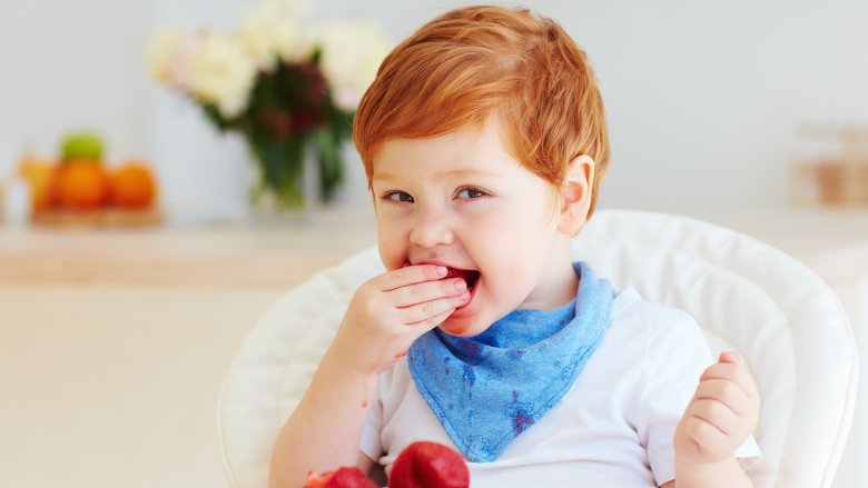 Baby eating berries