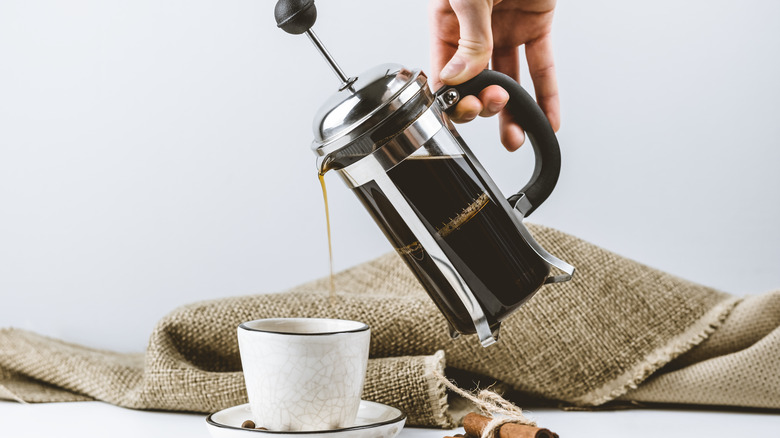 Person pours french press coffee 