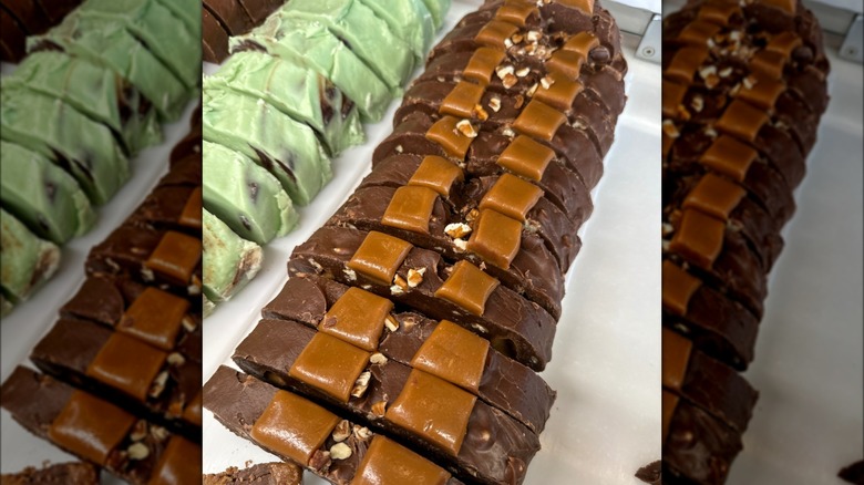 Sliced loaf of chocolate fudge on white platter