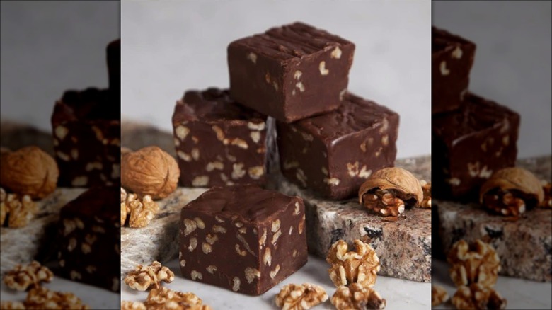 Chocolate fudge and nuts on marble surface