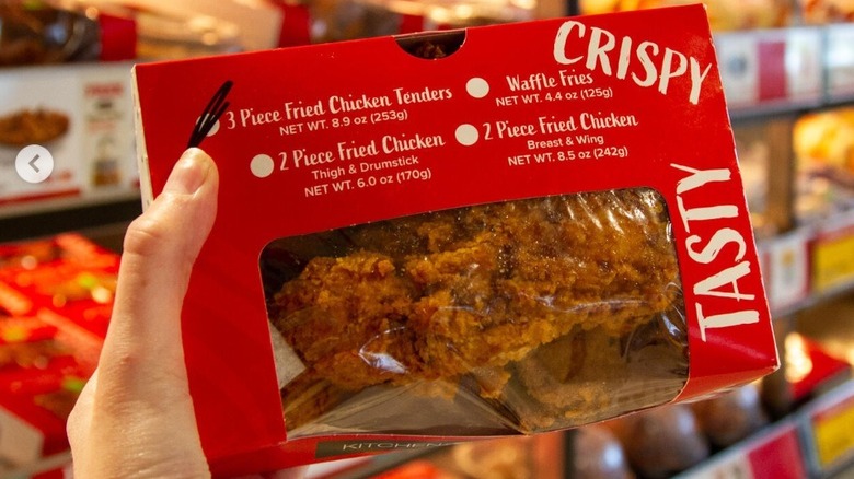 hand holding a box of Kwik Trip tenders