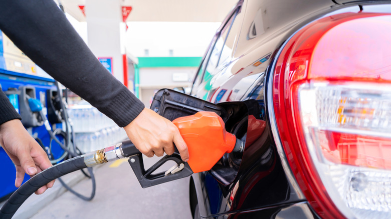 Person pumping gas at station