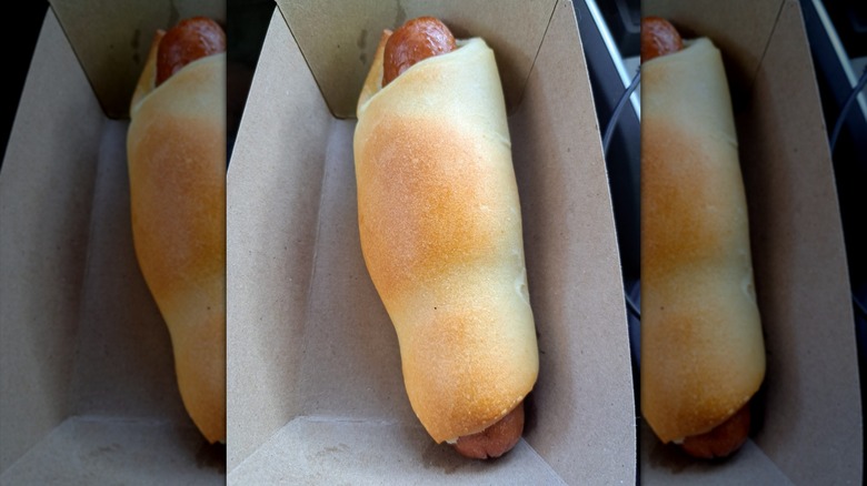 Dough-wrapped hot dog in cardboard tray
