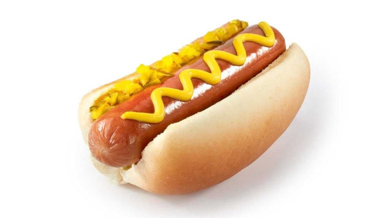 QuikTrip hot dog with yellow mustard and pickle relish on white background