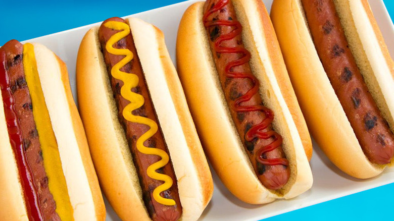 Four Wawa hot dogs with ketchup and mustard on plate