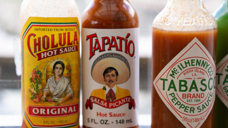 Close-up of several bottles of hot sauce