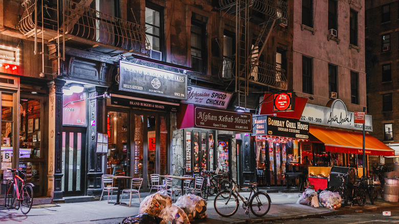 A row of small NYC restaurants at night