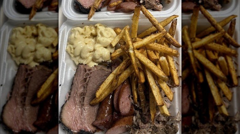 Takeout box filled with brisket, macaroni and cheese, and fries