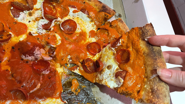 pulling out slice of pizza