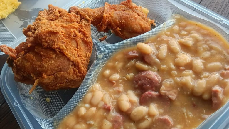 Li'l Dizzy's Cafe fried chicken with white beans and sausage in takeout tray
