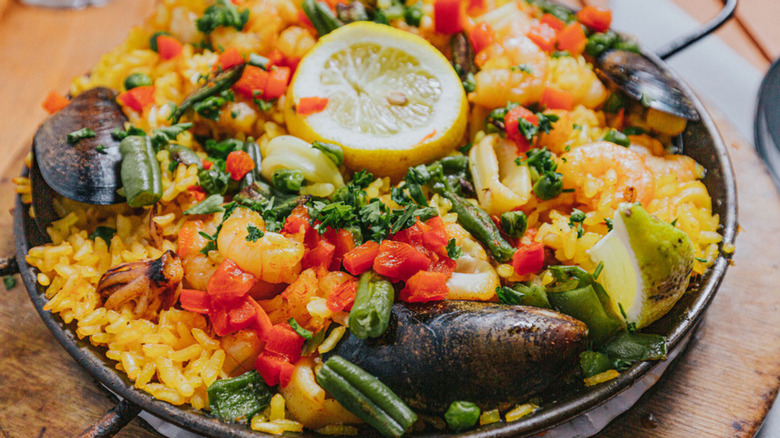 Lola's seafood paella with shrimp, mussels, vegetables, herbs, and lemon slices