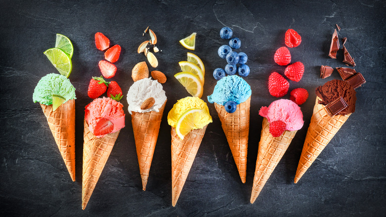 various ice cream cones against a black background