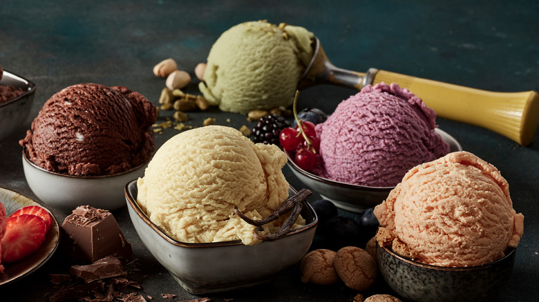 5 scoops of different flavored ice cream in dishes 