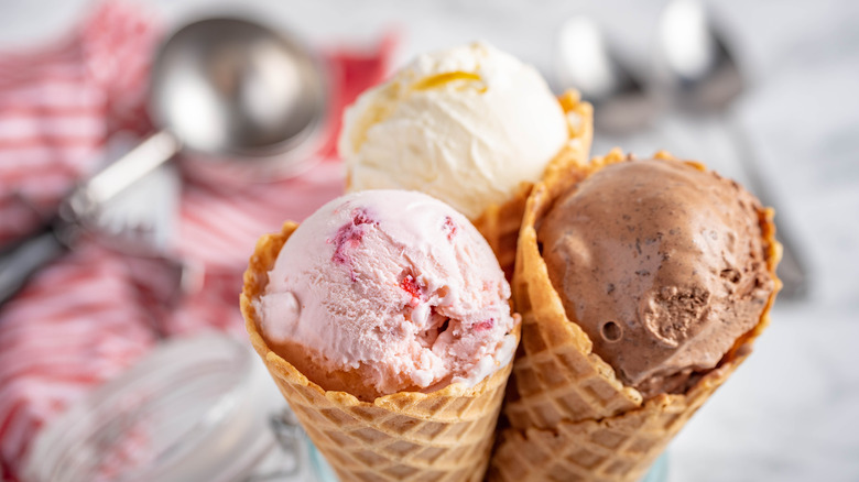 Three scoops of ice cream in waffle cones