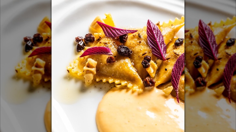 Ravioli in a dish garnished with raisins