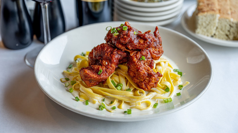 Hot chicken pasta alfredo in a white bowl