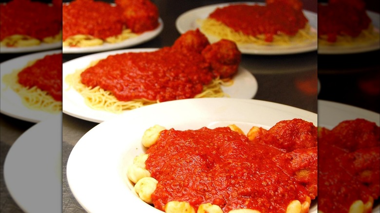 Several plates with different types of pasta with tomato sauce