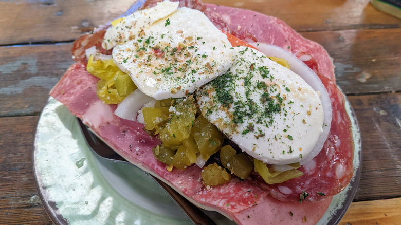 Large Italian Grande sub from Milano's Deli on plate.