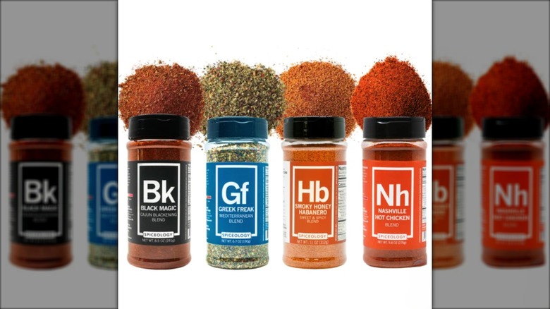 four different bottles containing assorted spices