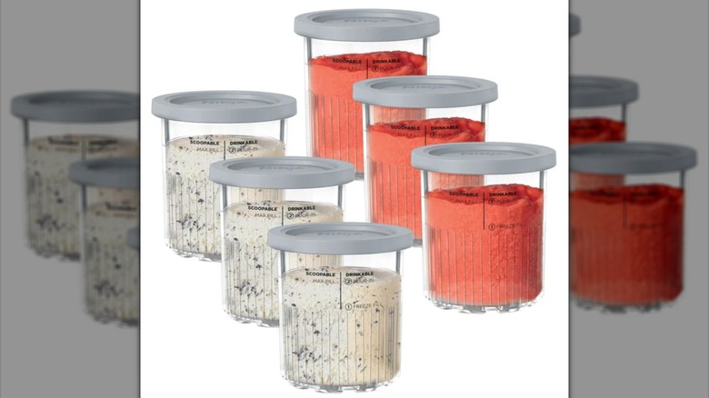 Six containers with lids filled with frozen treats