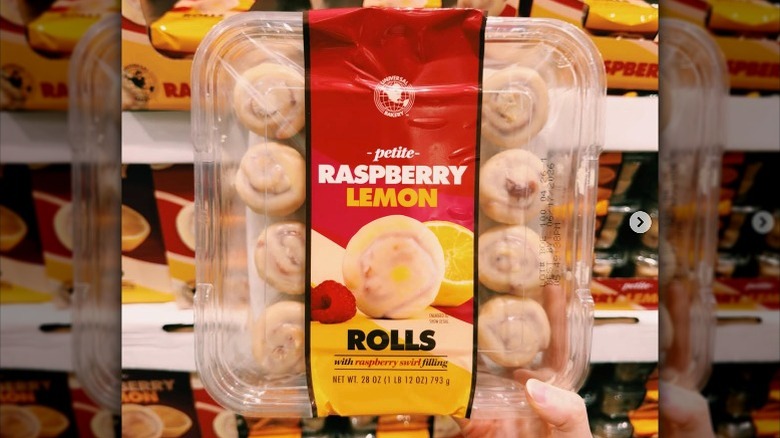 Hand holding up a package of Universal Bakery Petite Raspberry Lemon Rolls in store