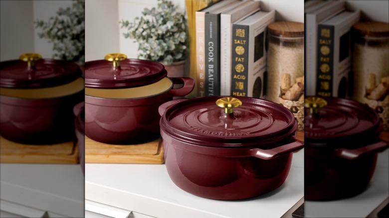 Two Dutch ovens with lids on a kitchen counter.