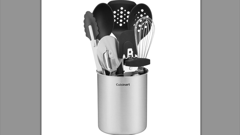 Stainless steel canister with assorted kitchen tools inside.