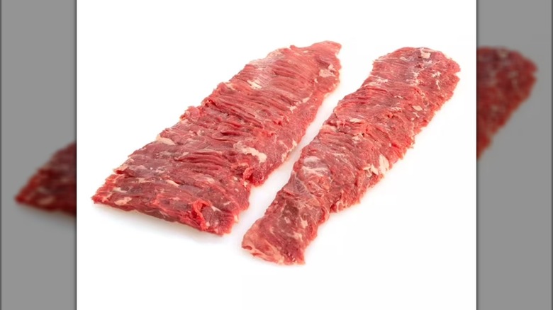 Raw beef skirt steak against a white background.