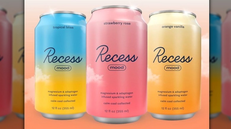 Three colorful cans of Recess Mood sparkling water in different flavors