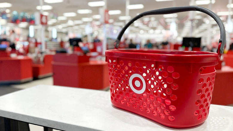 Empty Target basket on table in front of checkout.
