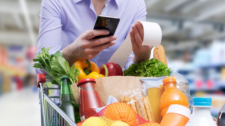 grocery shopper checking receipt