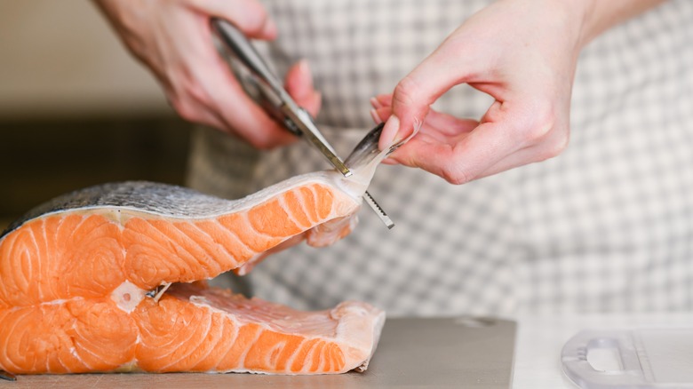 Cutting fish with kitchen shears