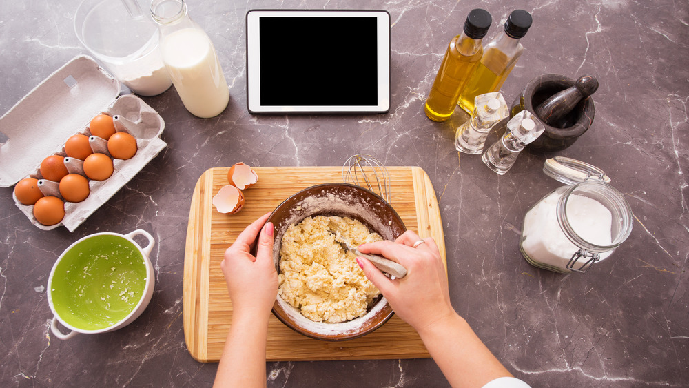 Woman making dough with tablet