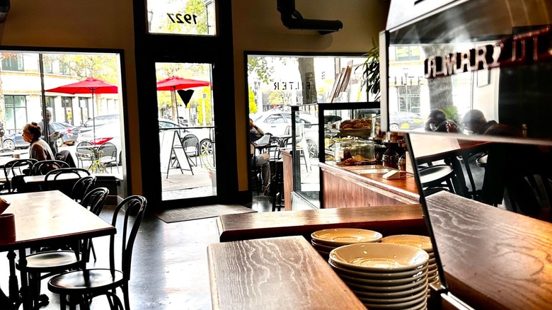 The interior of Filter Coffee Parlor, with a an espresso machine, some tables, and front counter in view
