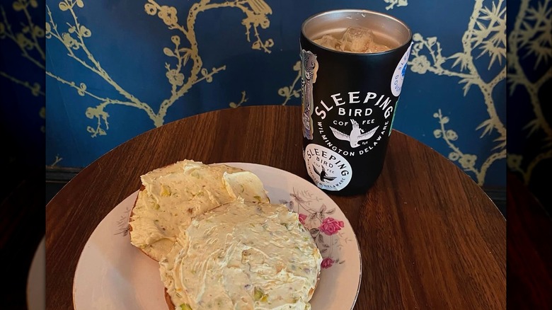 An iced latte in Sleeping Bird Coffee next to a plate of frosted cookies