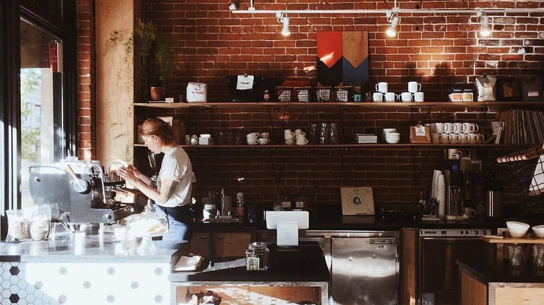 A barista prepares an order at Slow by Slow Coffee Bar in Idaho