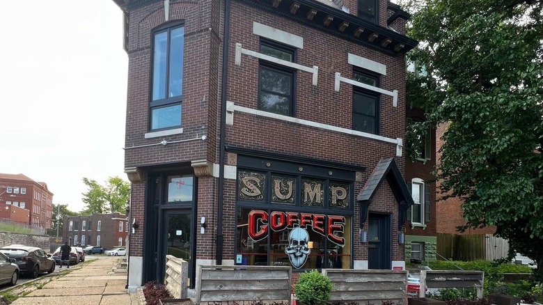 Exterior of a brick building with the words "Sump Coffee" painted on the window