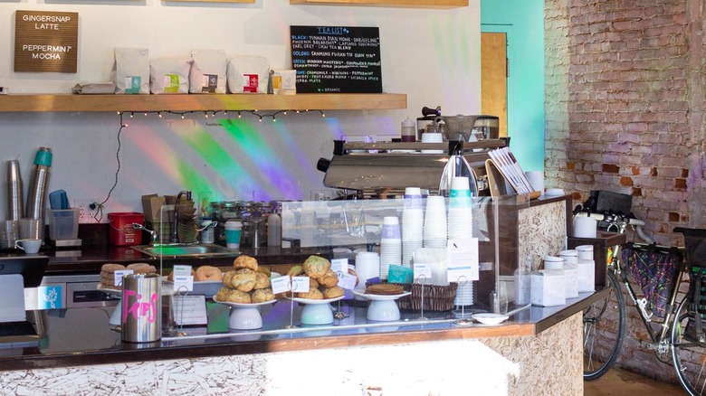 Pastries, paper cups, and other items site on the café counter at Phoenix Coffee Co.