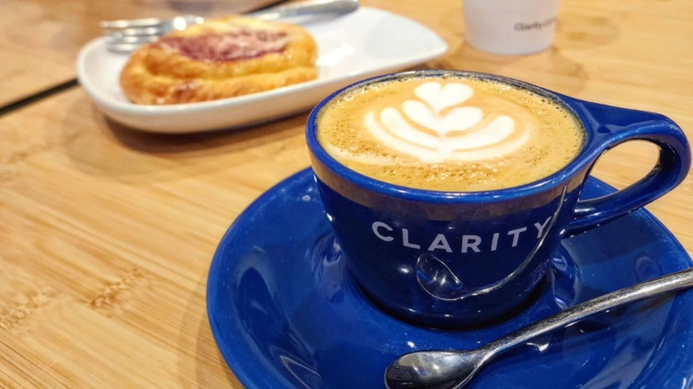 Latte in a blue Clarity Coffee mug on a blue saucer
