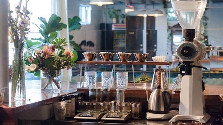 View of a pour-over bar from behind a café counter
